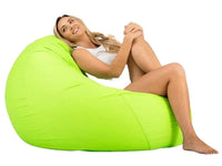 Woman sitting on a green bean bag chair against a white background