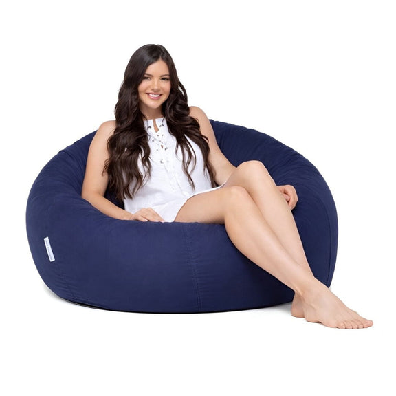teenage girl sitting on a navy cotton beanbag chair