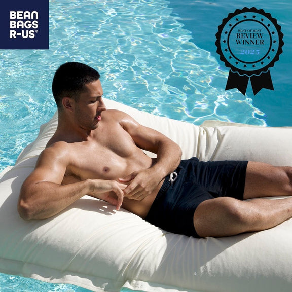 Man lying on a bean bag in a pool with 'Bean Bags R Us' branding and a 'Review Winner' badge.