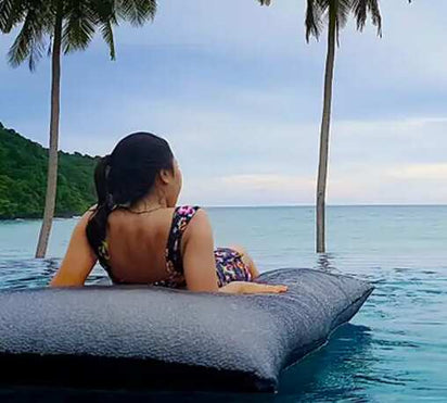 lady sitting on pool bean bag in resort