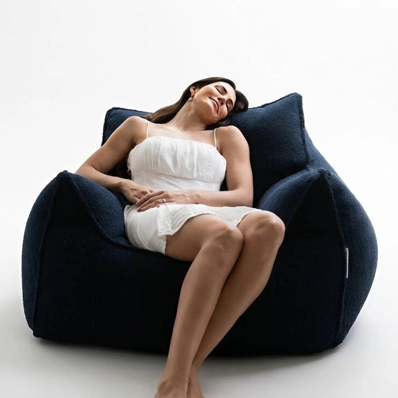 lady falling asleep on a fleece navy beanbag chair